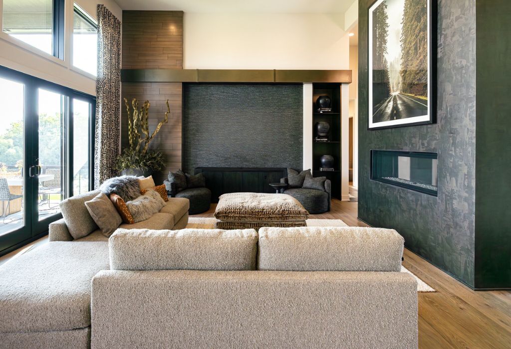 Living space with a large modular sofa and faux finished fireplace designed and furnished by Lee Douglas Interiors.